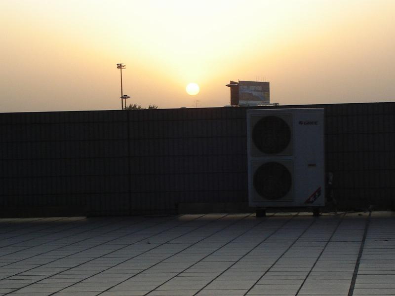 DSC01852.JPG - Sunset in Beijing.  Since we crossed over the International Date Line enroute, we lost almost all of Tuesday 20 October. 20 October 2009