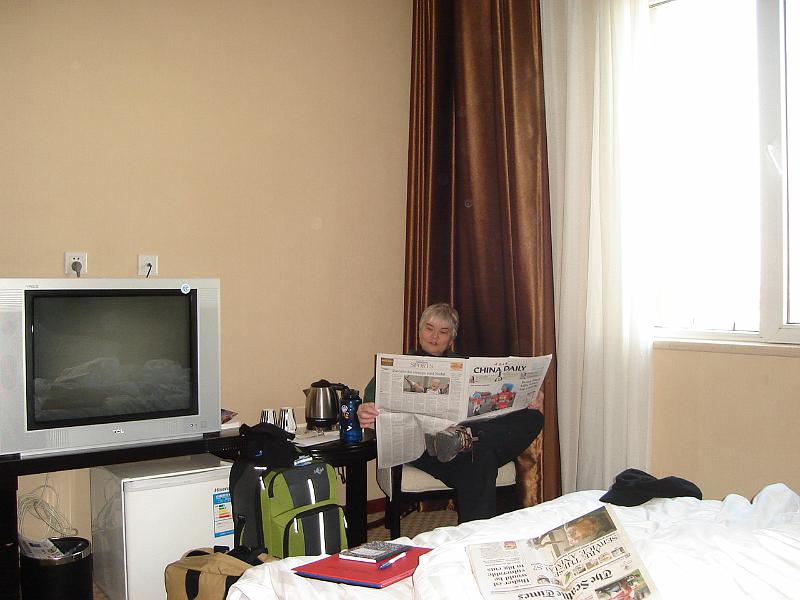 DSC01857.JPG - Our hotel room.  Judy is reading the China Daily.  Note the Seattle Times on the bed. 21 October 2009