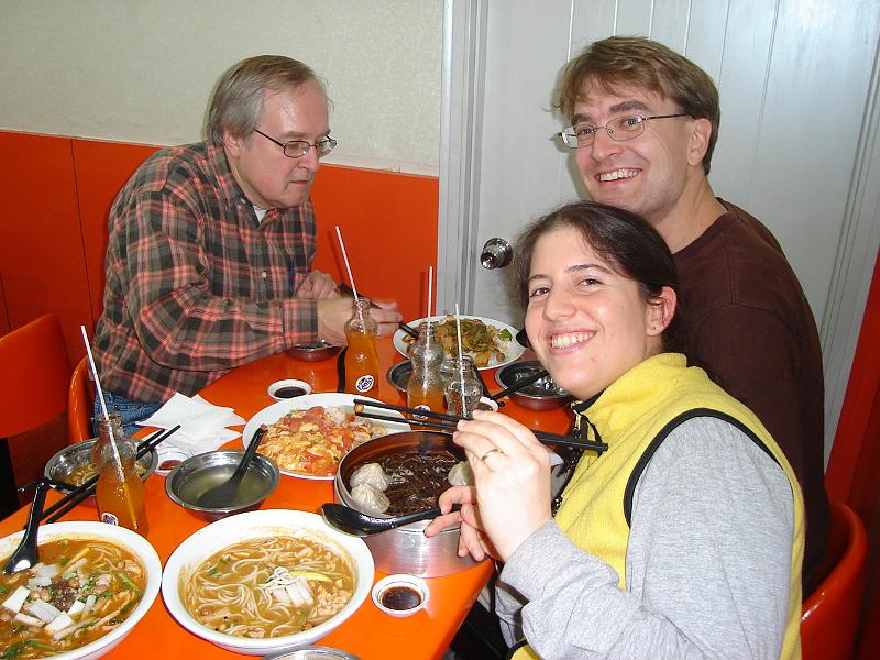 DSC01880.JPG - Getting used to chopsticks.  Our dinner was one ring of tang bao, egg and tomato over rice, beef and potato over rice, pork soup, chicken soup, and si ping Fanta. 21 October 2009