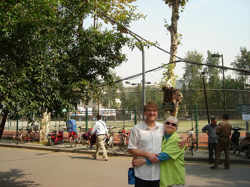 DSC01907.JPG - Andrew and Judy in front of the athletic fields at Southeast University. 22 October 2009