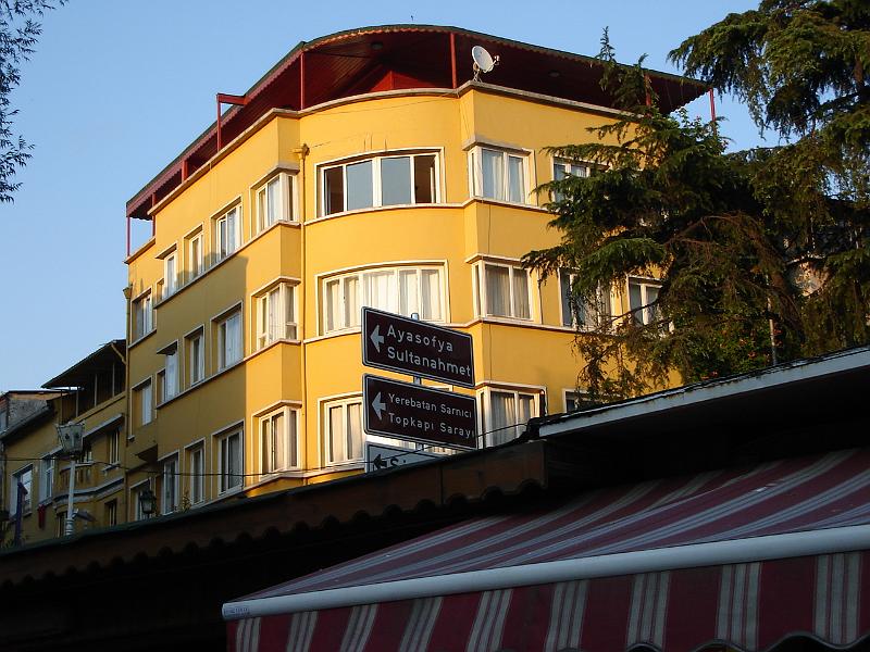DSC01011.JPG - Colorful building off the restaurant with signage for the Haghia Sophia (Aya Sofya) and the Topkapi Palace (Topkapi Sarayi). 12 July 2007