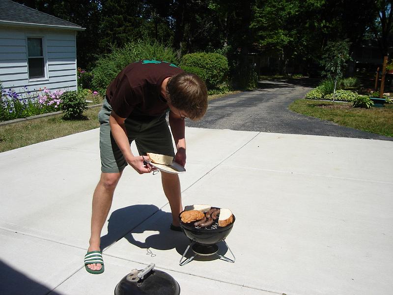 DSC01466.JPG - Andrew grilling brats and buns. 21 July 2007