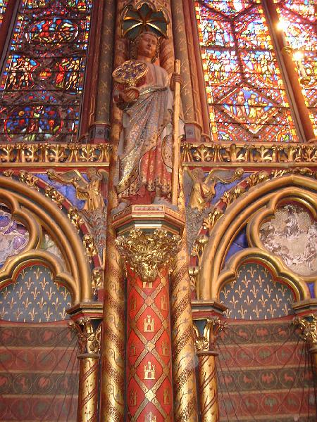 DSC02648.JPG - Painted and embossed columns, arches and walls, with stained glass windows of the upper level of Sainte Chappelle.  Paris France 27 April 2008