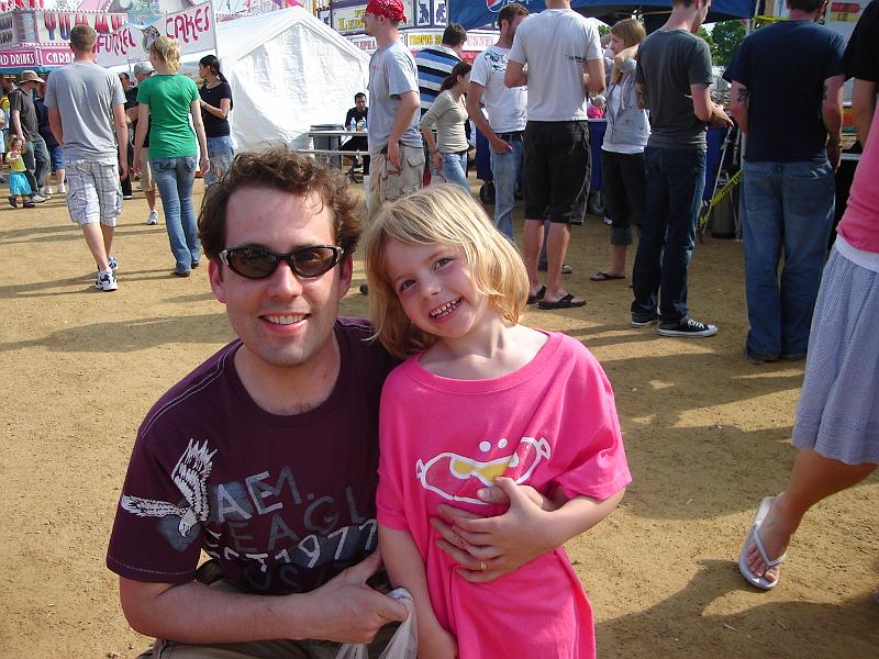 DSC01094.JPG - This is Bella.  She dumped an orange drink all over her striped dress, so her daddy had to buy her a pink T-shirt.  We got to know them while eating our brats at a shared picnic table. 23 May 2009