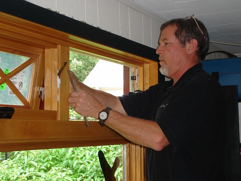 DSC01479.JPG - Tom finishing the awing windows on the inside.   17 August 2009