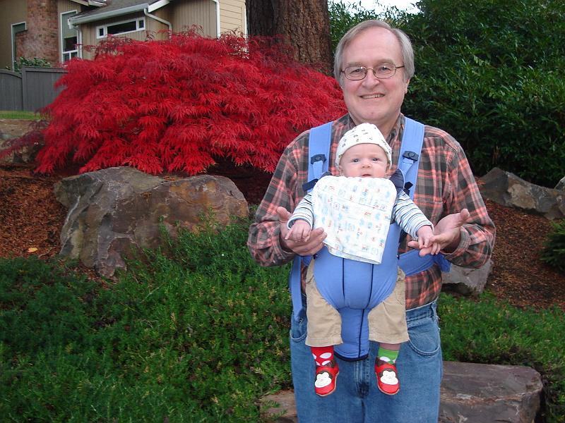 DSC01833.JPG - Sebastian in the Baby Bjorn and Grandpa on a walk.  (Note the monkey shoes from Great-Aunt Marci and Great Runcle On and the mis-matched socks from Janet and Dave.) 18 October 2009