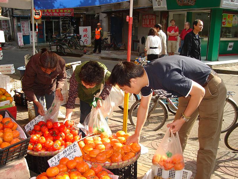 DSC02010.JPG - Andrew and Bill supervising Judy and Brenda buying fruit. 24 October 2009