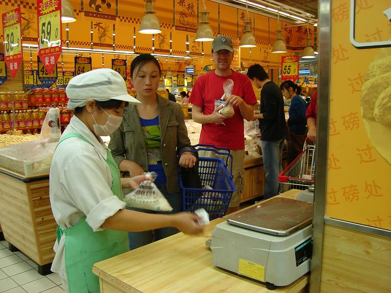 DSC02042.JPG - Andrew waiting to get his flour weighed at the RT Mart. 24 October 2009