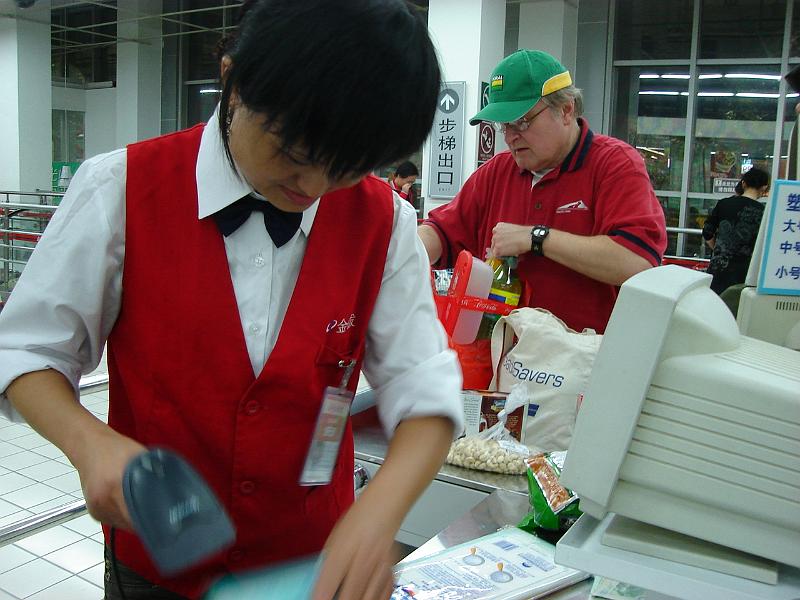 DSC02044.JPG - Checking out and Bill bagging at the RT Mart. 24 October 2009
