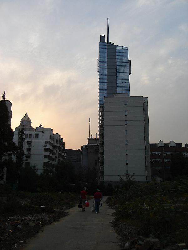 DSC02046.JPG - Coming back to Andrew and Brenda's apartment building with our purchases at sunset with Nanjing's highest building in the background. 24 October 2009