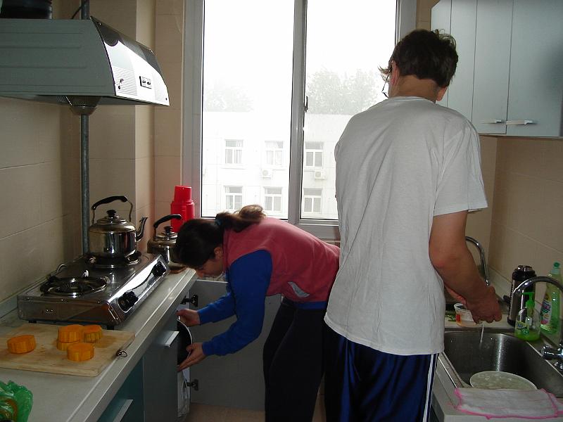 DSC02051.JPG - Andrew washing eggs and Brenda finding the pan. 25 October 2009