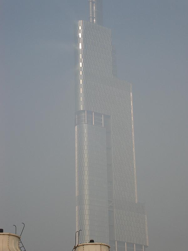 DSC02058.JPG - Nanjing's tallest building shimmering in the sun, with a fog flare on the left. 25 October 2009