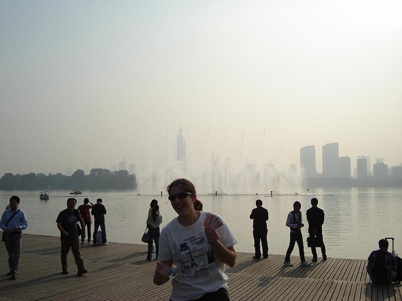 DSC02129.JPG - Brenda in front of the dancing fountains at the Nanjing Railroad Station.  She sucessfully got our tickets to Shanghai.  That evening, we had a formal dinner with Dr. Ni and his son Nikon, which included such things as taro root, water caltrop, green onions and snail, egg fish custard, pork liver, and whole prawns. 26 October 2009