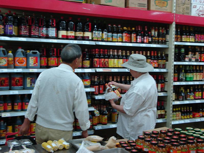 DSC02280.JPG - Judy comparing labels on what Brenda has and what Brenda needs.  A Chinese gentleman is helping. 29 October 2009