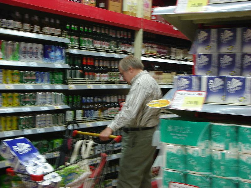 DSC02282.JPG - Bill perusing the beer selection after finding the brand of toilet paper Andrew and Brenda use. 29 October 2009