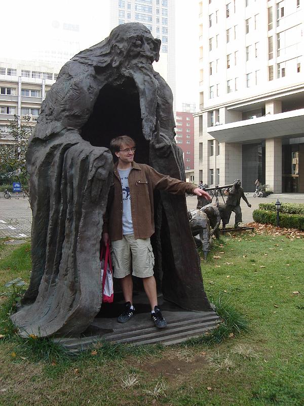 DSC02476.JPG - Andrew beckoning from the inside of a sculpture on the Nanjing University campus. 1 November 2009