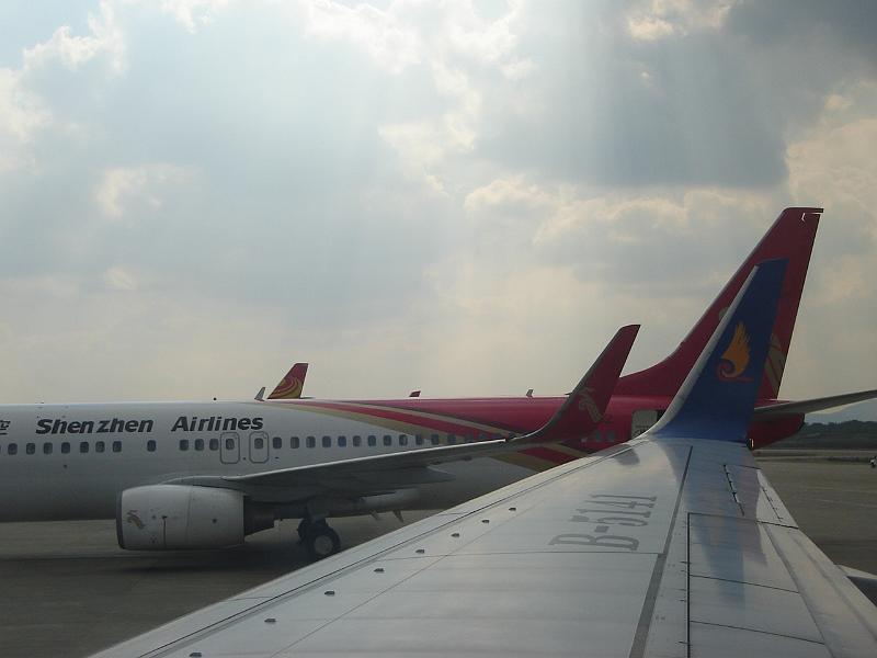 DSC02532.JPG - On the tarmac of the Nanjing airport,  through Judy's window on our flight, the wing of our plane with several other planes close by. 2 November 2009