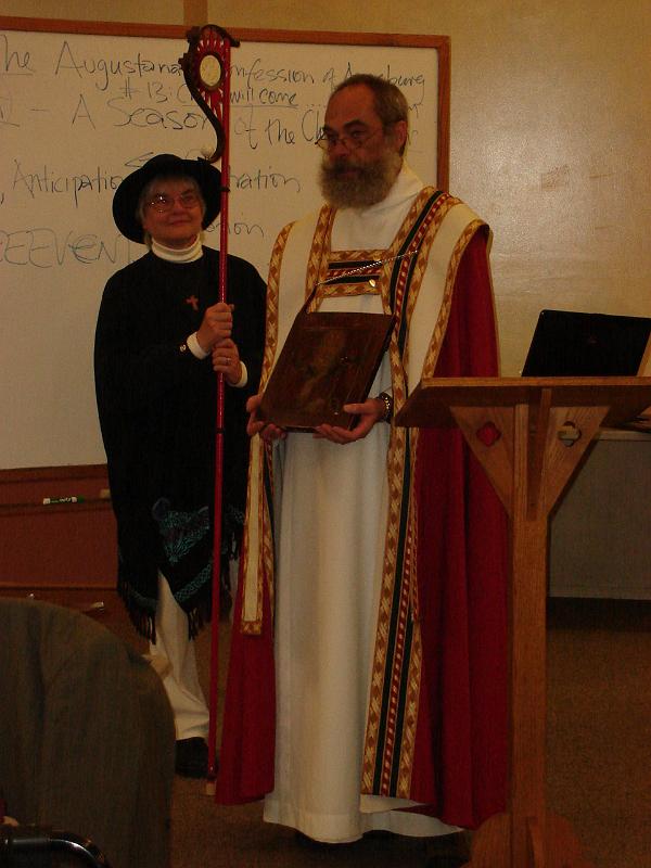 DSC02652.JPG - St Nicholas holding a mid-19th century Russian Orthodox icon of St Nicholas Thaumaturge,  with elaborate oklad (early 20th century).  His acolyte (Judy) holds the crosier. 6 December 2009
