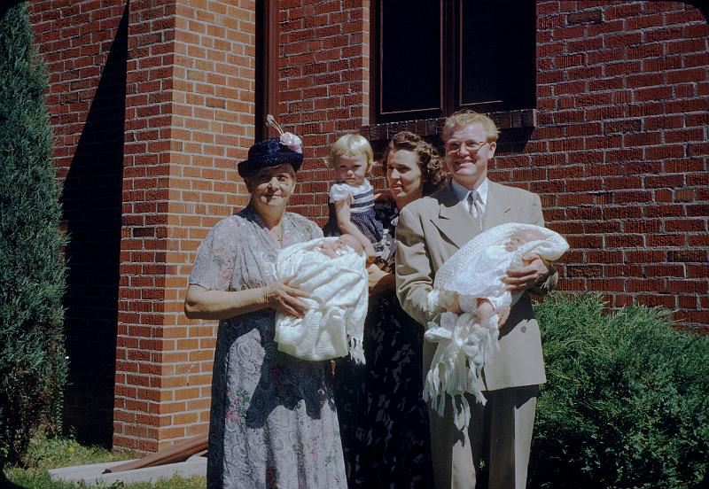 0110-bapt00.jpg - Grandma Thaemert holding Judy, Marcia being held by Betty, Amos holding Richard.  Baptism day, Grace Lutheran Church, Birch and 14th, Denver 3 September 1950