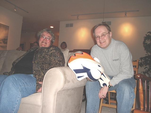 Bill-Phyllis-horsehead.jpg - Bill and Phyllis watching the game with the assistance of Judy's favorite team's paraphernalia - the Denver Bronco Horse Head! 5 February 2006
