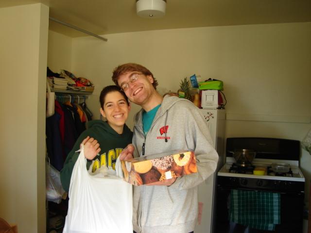 DSC00134.JPG - Celebrating Andrew's Golden Birthday early on 25 February, he will be 28 on Tuesday, the 28th of February, with 28 crullers.  Brenda seems pleased as well. 25 February 2006