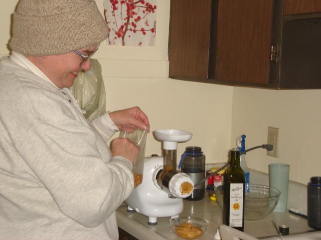 DSC00138.JPG - Judy making soy nut butter in Andrew and Brenda's kitchen. 25 February 2006