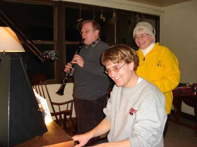 DSC00180.JPG - Andrew, on Farley, the piano, and Bill, on clarinet, playing "Lied to the Moon" while Judy talks to Gretchen. 25 February 2006