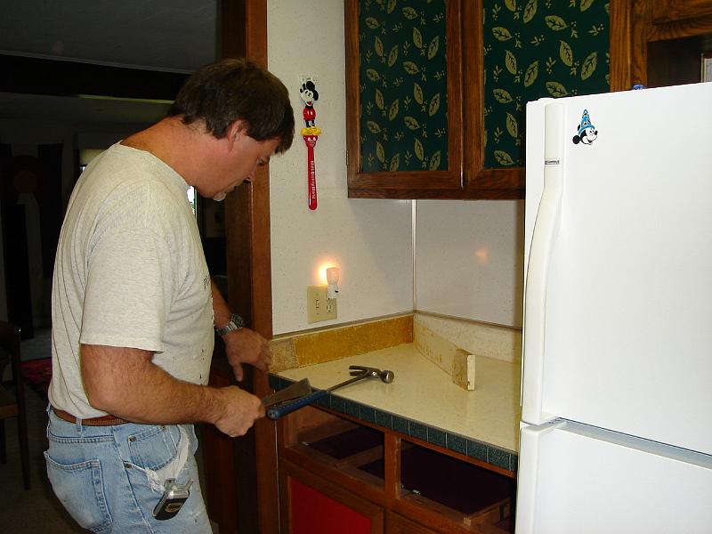 DSC00458.JPG - MIke starting on counter top removal.  2 October 2006