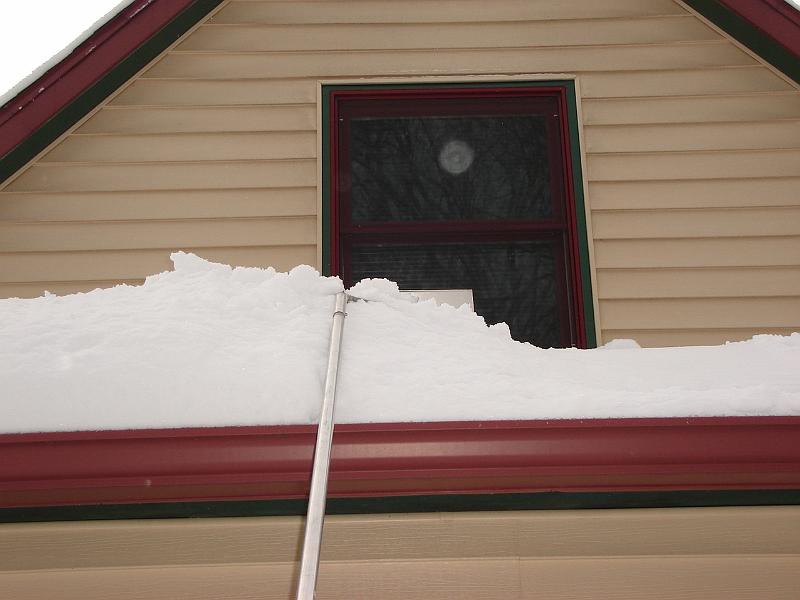 DSC02188.JPG - Judy raking snow off the front of the house.  Only two and half more inches to go to break the record for the snowiest December in Madison. 29 December 2007