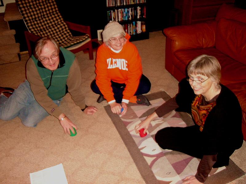 DSC02195.JPG - Bill, Judy, and Yvonne engaged in a fierce game of Perudo.  The photographer, that would be Randy, has already lost so he takes the picture. 31 December 2007