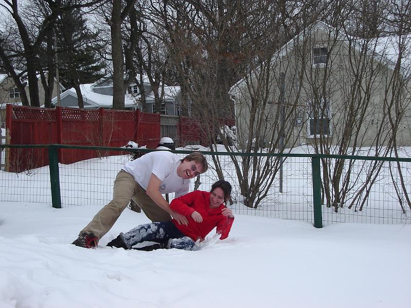 DSC02251.JPG - Andrew assisting Sara after a major snow fall, note depth of snow by fence posts and Andrew's right leg. 1 March 2008