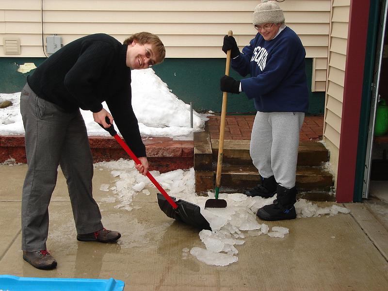 DSC02276.JPG - Andrew and Judy chopping ice off the driveway. 2 March 2008