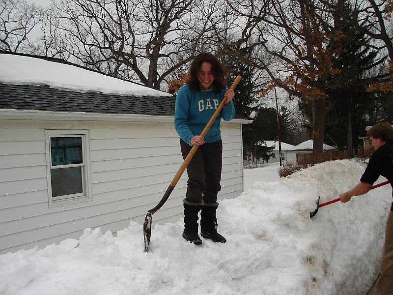 DSC02277.JPG - Sara and Andrew moving some of the huge piles of snow from between the houses to the front yard. 2 March 2008