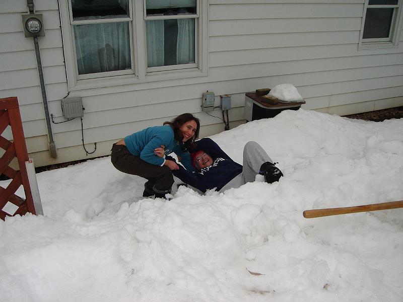 DSC02279.JPG - Sara assisting Judy after she inadvertently stepped off the snow buried concrete wall between Helen's house and ours and sunk deep into the snow. 2 March 2008