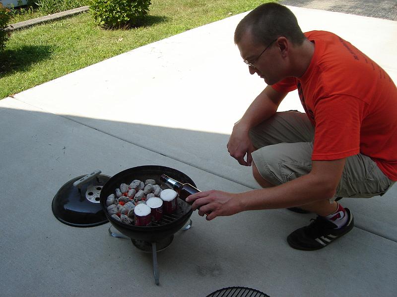 DSC00246.JPG - Andrew trying a new way to make beer brats! 1 September 2008