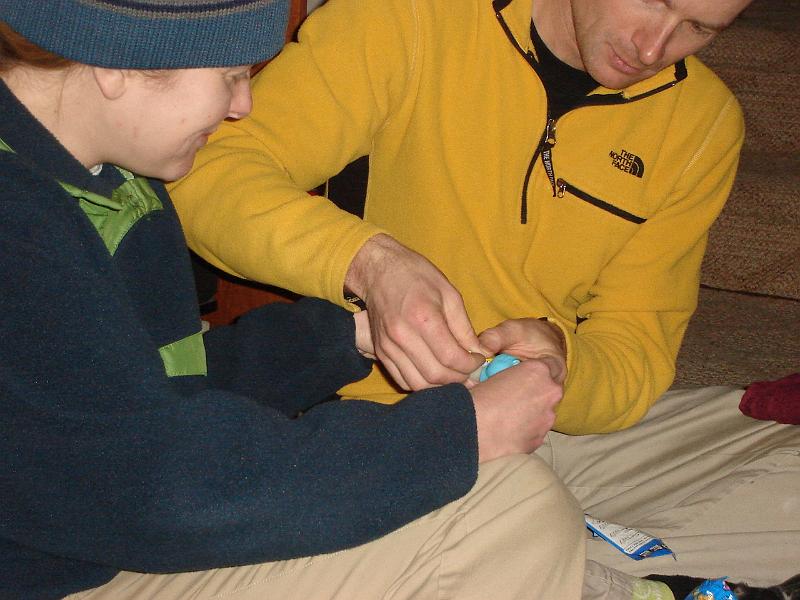 DSC00690.JPG - Gretchen + 1 helping Matt fill his first ever Pez dispenser.  It is Sulley from Monsters, Inc. 30 December 2008