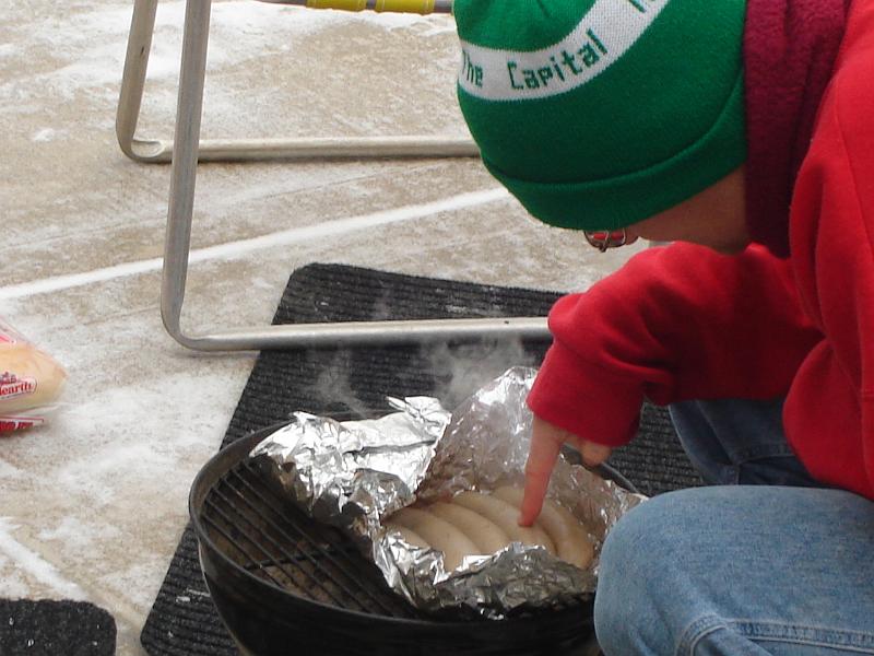 DSC00746.JPG - Andrew checking brats.  We went for the pre-cooked variety, not boiled in beer as in previous years. 1 January 2009