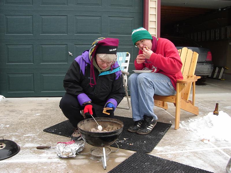 DSC00763.JPG - Judy starting the s'mores.  Andrew trying to control the powdering of the bun. 1 January 2009