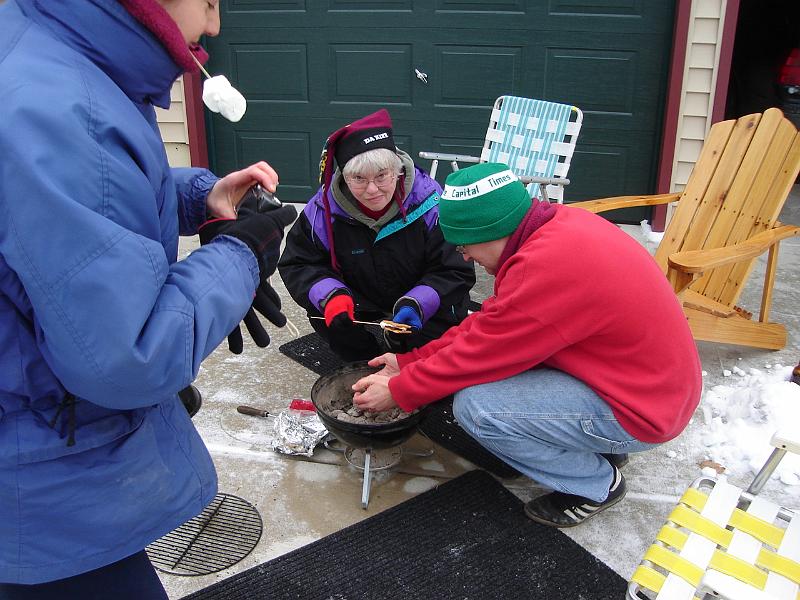 DSC00765.JPG - More s'mores; Andrew warming hands. 1 January 2009