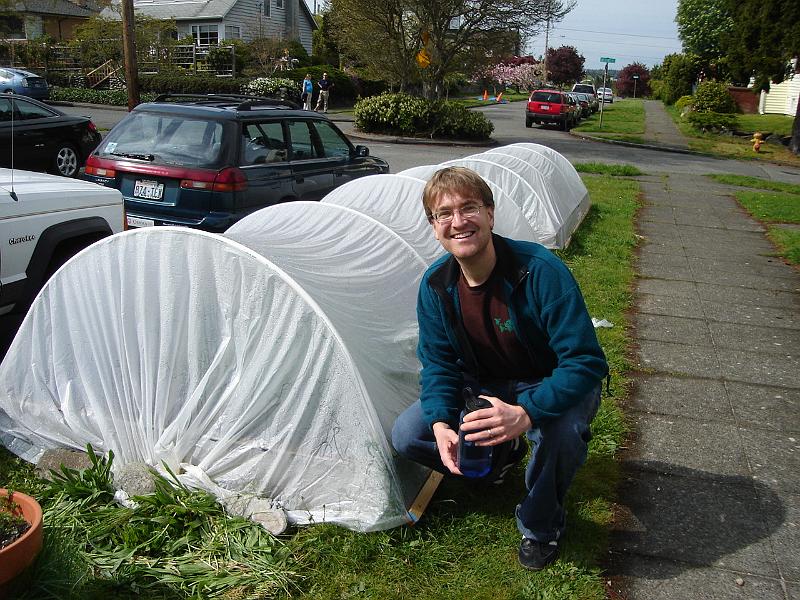 DSC00941.JPG - Andrew with a front-yard greenhouse in Seattle, Gretchen and Matt in the background. 2 May 2009