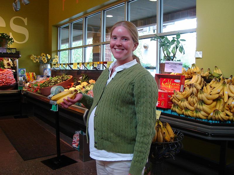 DSC00966.JPG - Gretchen (including Little Man) at the banana section of the local health food store. 3 May 2009