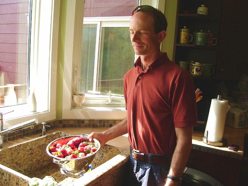 DSC00969.JPG - Matt getting some fresh strawberries ready for consumption. 3 May 2009